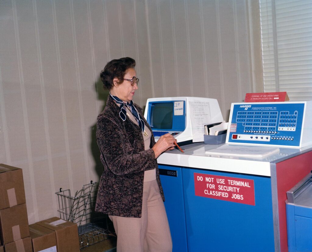 A Black woman operates a secure computer terminal